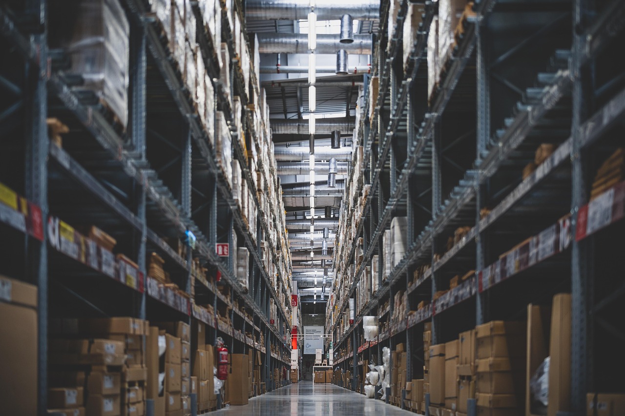 Warehouse shelves holding neatly stacked stock and inventory